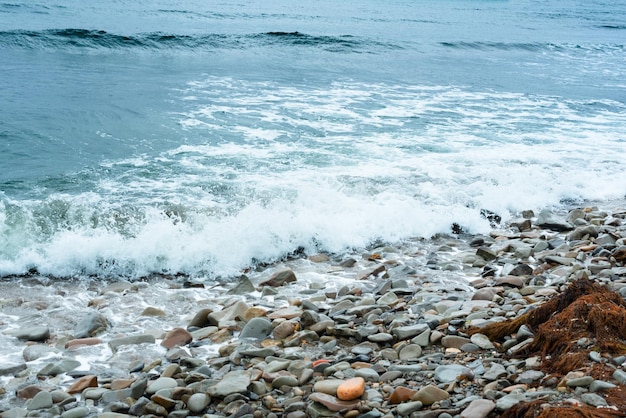 Nature background with sea waves hitting the sea shore Scenic view of sea against cloudy sky