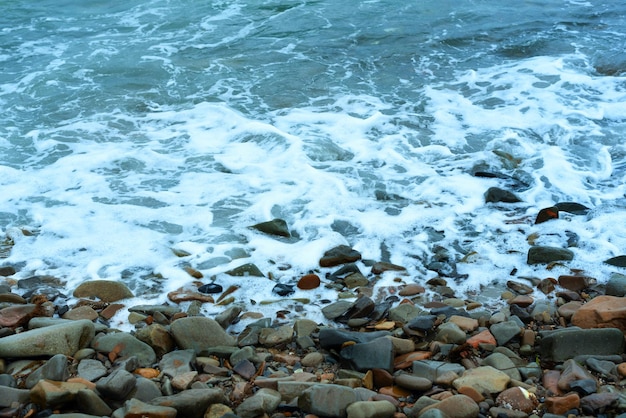 Nature background with sea waves hitting the sea shore Scenic view of sea against cloudy sky