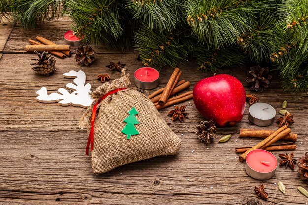 Nature Christmas decorations on vintage wooden boards with gift in sack