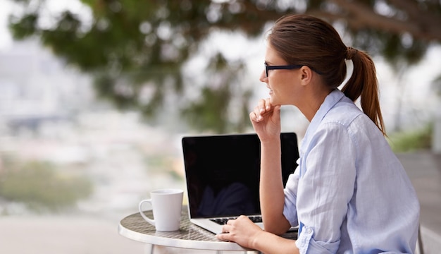 Nature is the best environment for work Shot of an attractive young woman using her laptop outdoors