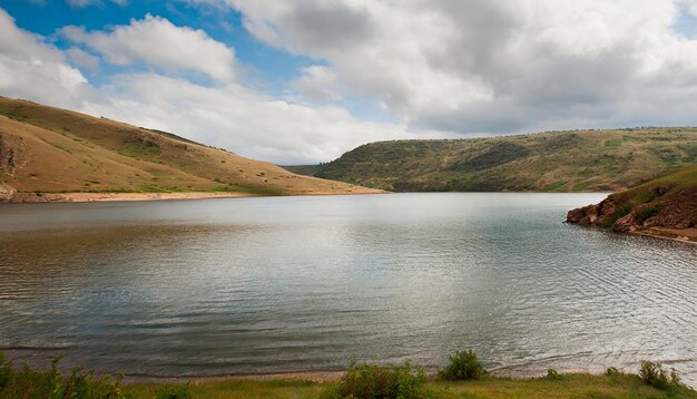 Photo nature landscape with a calm lake hills and cloudy sky