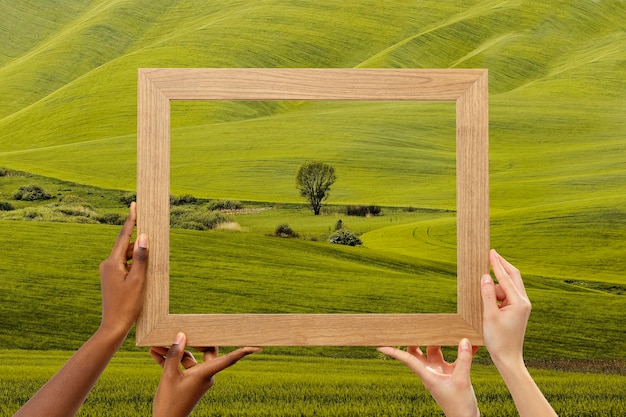 Photo nature landscape with hand holding frame