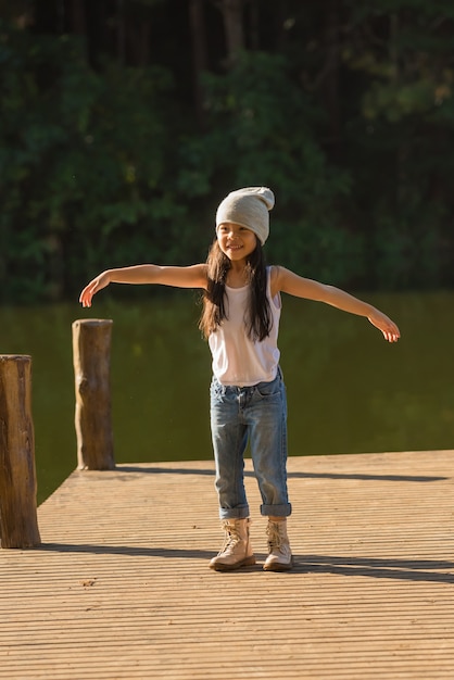 Photo nature little girl, has happy fun with cheerful smiling face.