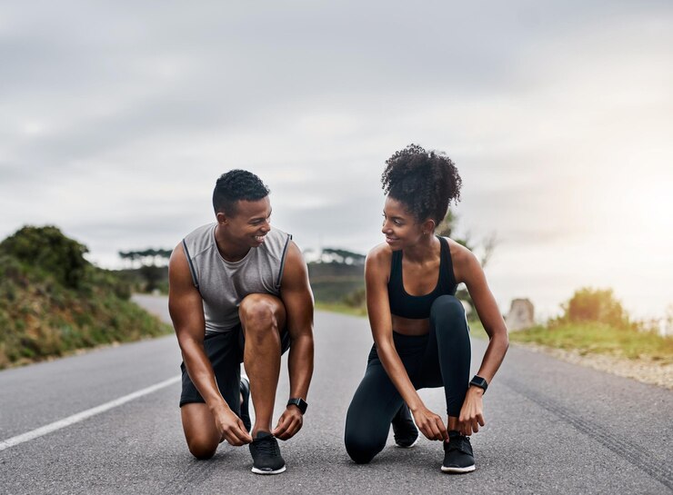 Photo nature sports and couple tie shoelace in road with running exercise for race or marathon training fitness outdoor and team of track and field athletes preparing for cardio workout in mountain