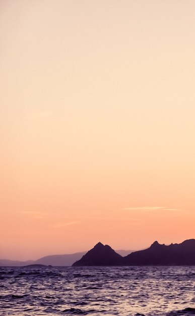 Nature twilight and vintage beach holiday concept  summer sunset at the mediterranean sea coast seascape and mountain view