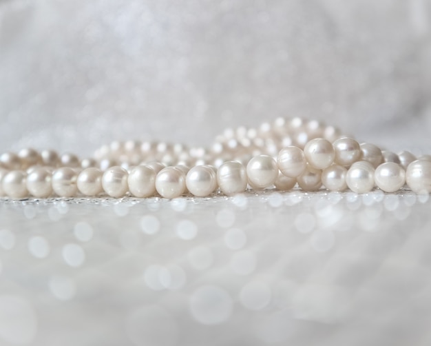 Nature white pearl beads on sparkling background