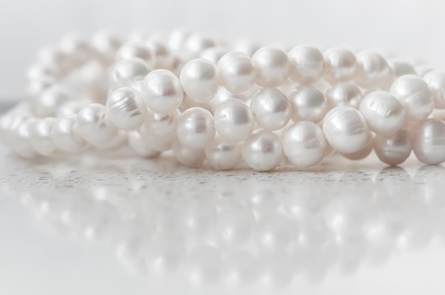 Nature white string of pearls on marble background in soft focus