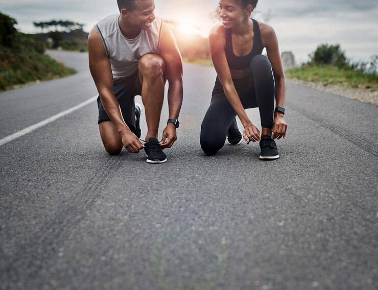 Photo nature workout and couple tie laces in road with running exercise for race or marathon training sports outdoor and team of track and field athletes preparing for cardio fitness in mountain
