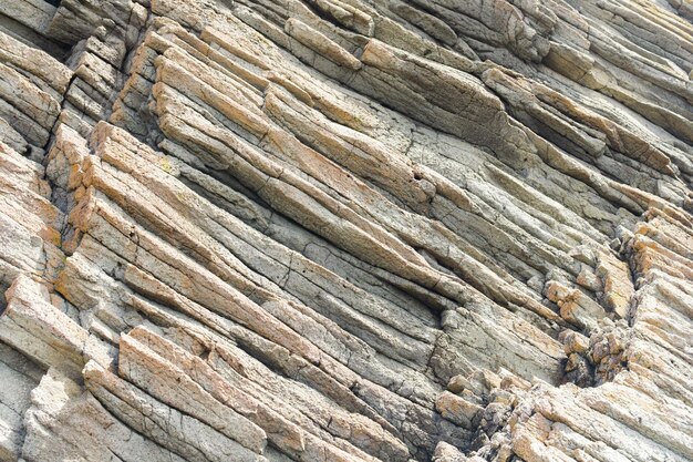 Natuurlijk achtergrondrotsfragment van vulkanische lavakolommen