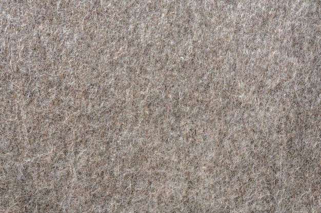 Natuurlijk beige vilt als abstracte achtergrond textuur en patroon van het materiaal