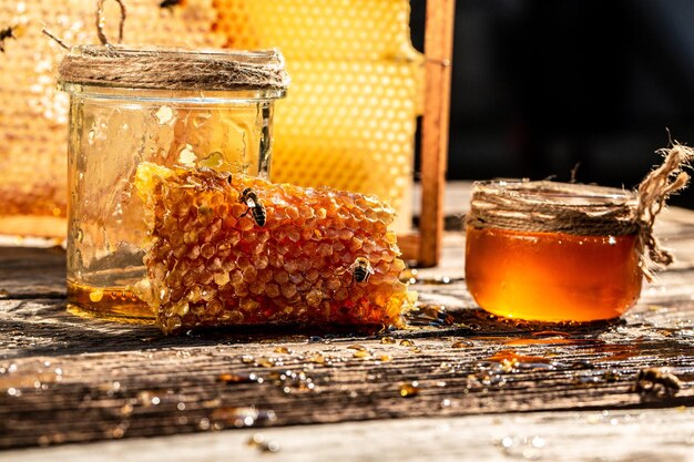 Natuurlijke honingkam en een glazen pot op houten tafel Honing achtergrond bijenproducten door organische natuurlijke ingrediënten concept close-up