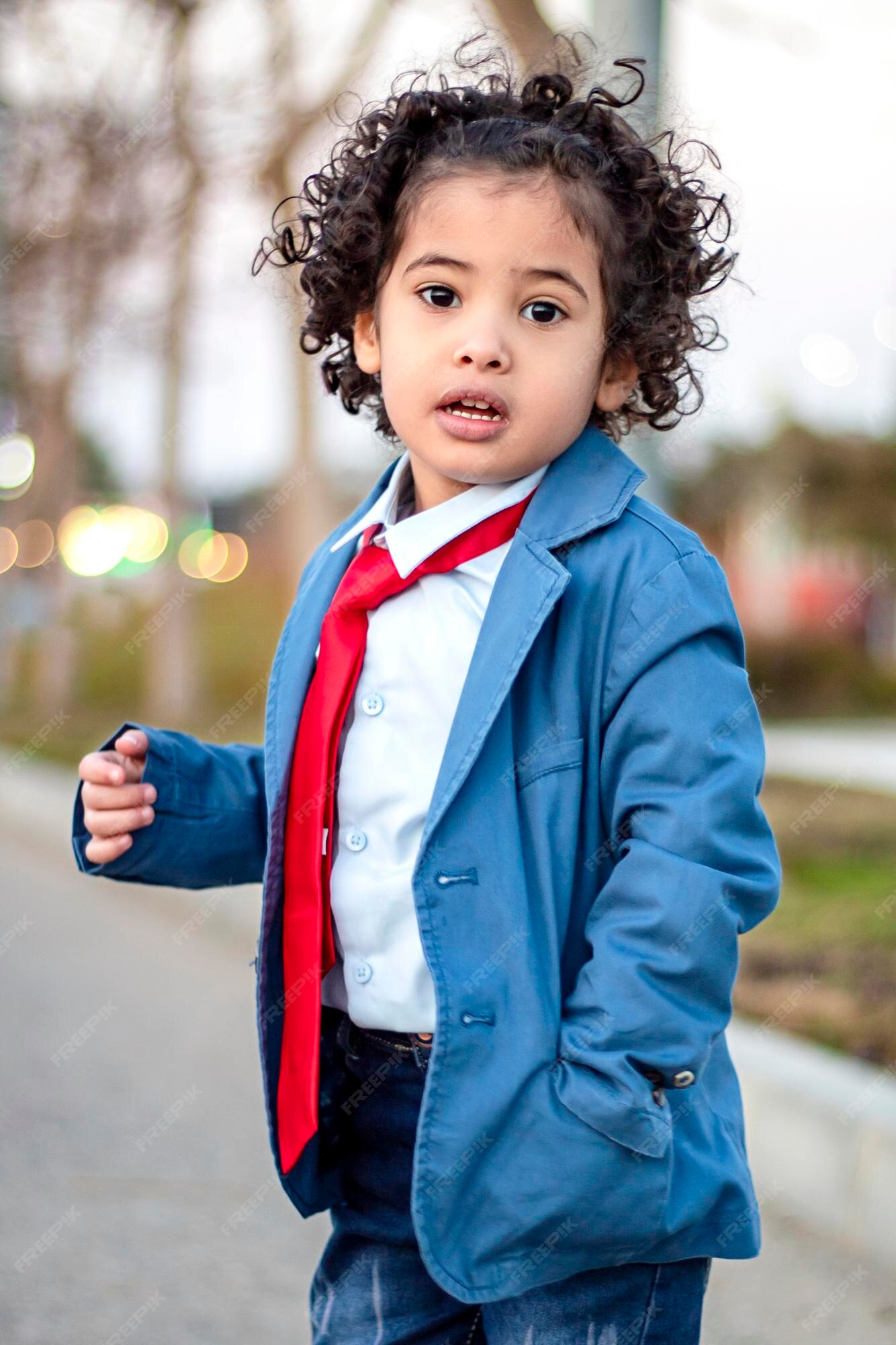 Premium Photo | A naughty and handsome little boy, with long hair,  elegantly dressed and his hand in his pocket