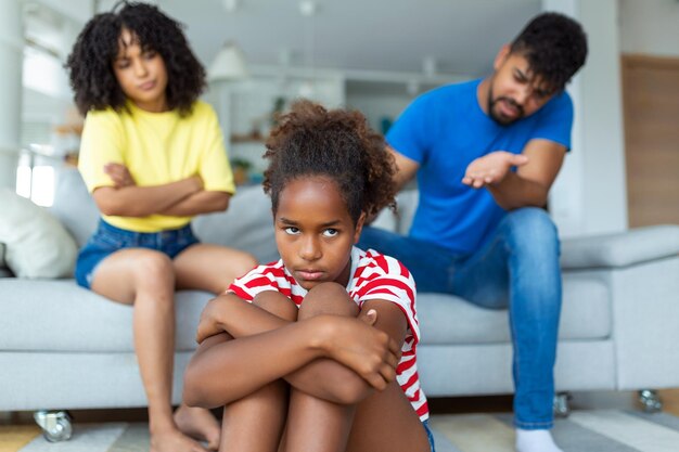 Naughty Kid Annoyed Parents Scolding Their Little Daughter For Her Behaviour While Sitting Together On Couch At Home