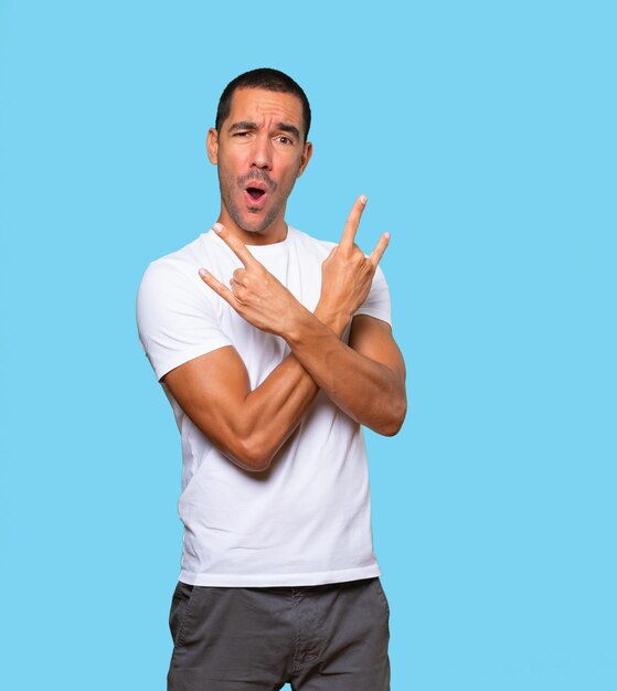 Naughty young man making a rock gesture