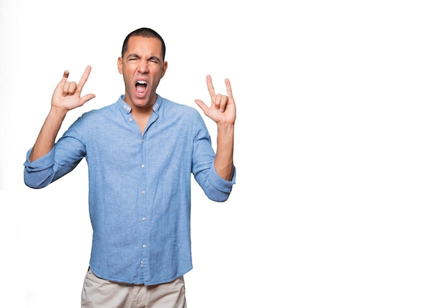 Naughty young man making a rock gesture