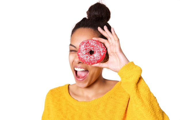 Naughty young woman looking through a donut 