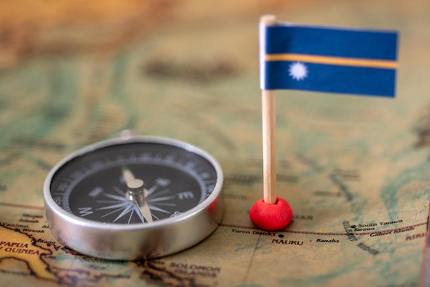 Nauru flag and compass on the world map