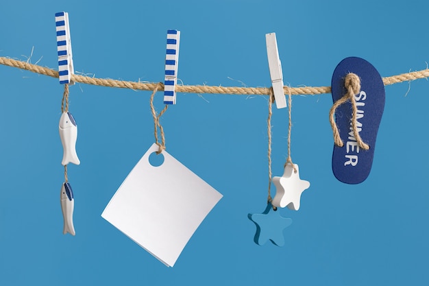 Nautical concept with sea lifestyle decorations hanging on rope with blue color