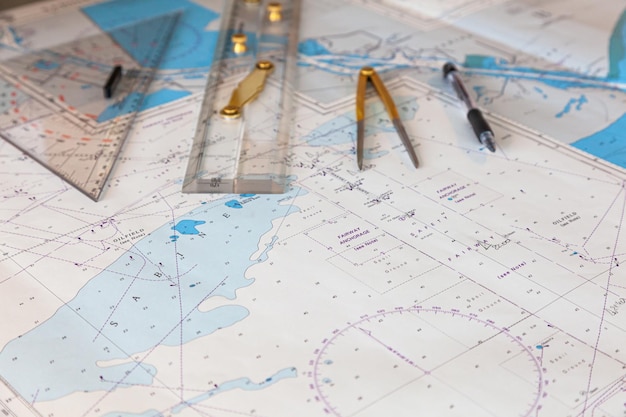 Photo navigation ship chart for building a sailing route plotter divider ruler and pen on a map