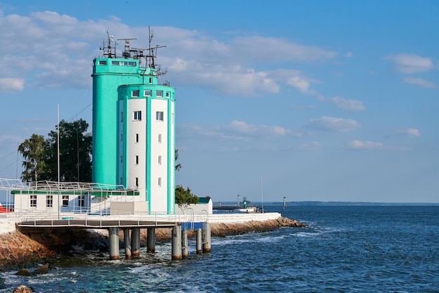 Navigation tower on Baltic sea coast in Baltiysk city. Ship navigation management center in pilot tower. Sea traffic control for logistic, monitoring wind speed and direction of flow.
