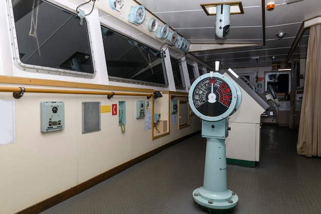 Navigational bridge on big cargo ship. Wheelhouse on vessel.