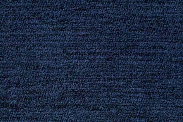 Navy blue background from soft textile material. Fabric with natural texture.