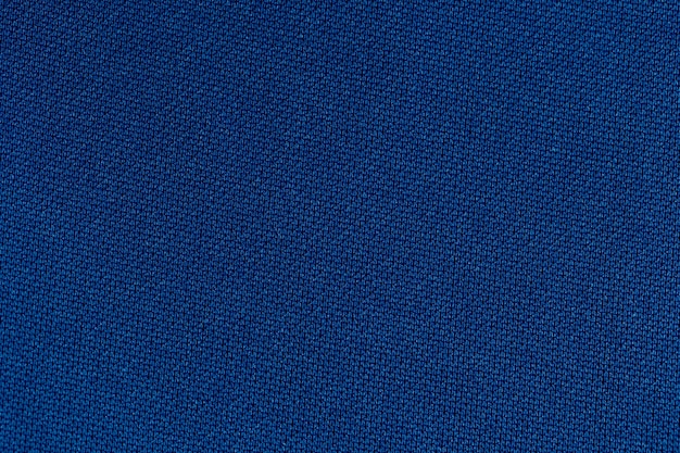 Предпосылка текстуры полиэстера ткани темно-синего цвета.