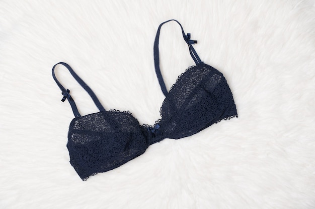 Navy blue lace bra on white fur