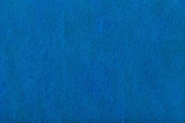 Темно-синий матовый замша ткани фона. бархатная текстура войлока.