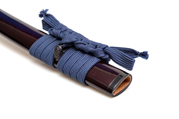 Navy Blue Sageo Navy blue silk rope for tying Shining crimson Japanese scabbard isolated on a white background Selective focus