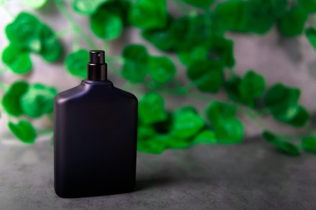 Navy blue spray bottle of cologne in the foreground