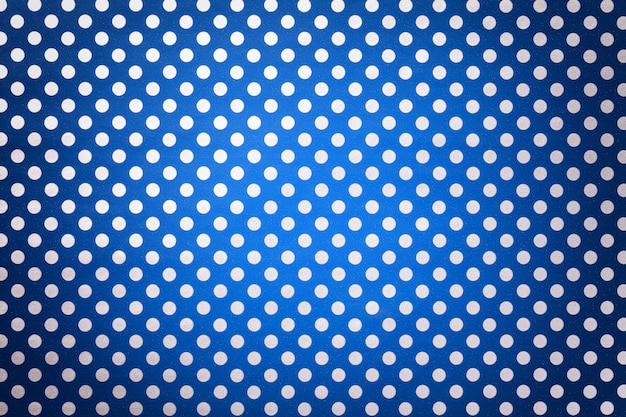 Navy blue wrapping paper with a pattern of white polka dots