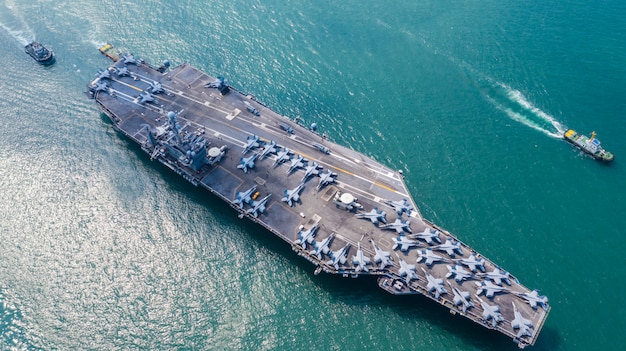 Navy Nuclear Aircraft carrier, Military navy ship carrier full loading fighter jet aircraft, Aerial view.