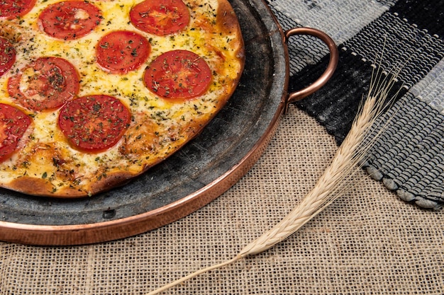 Neapolitan Brazilian pizza with mozzarella cheese and tomato slices with oregano