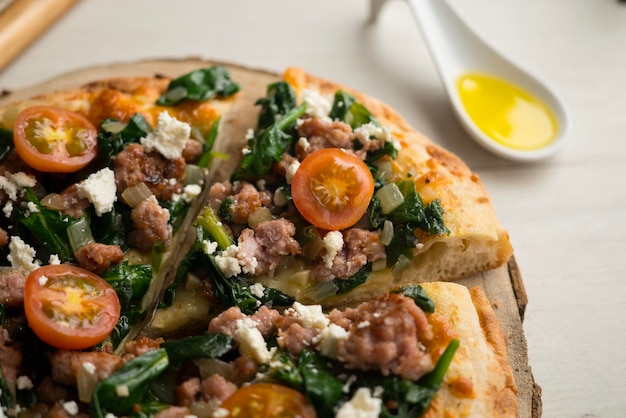 Neapolitan pizza with sausage and spinach