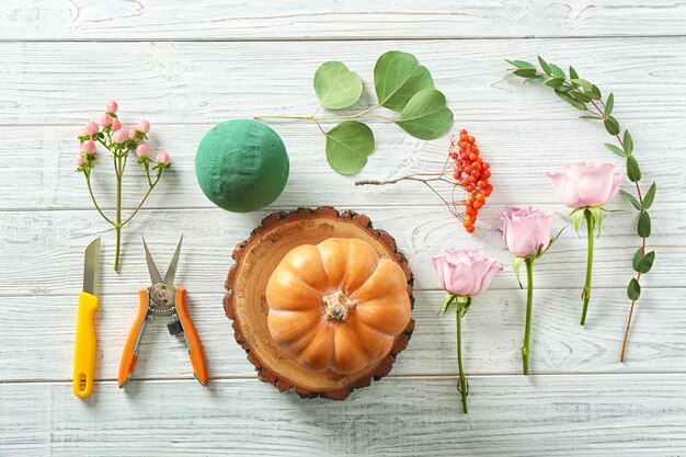 Necessary thing for making beautiful pumpkin composition on white wooden table