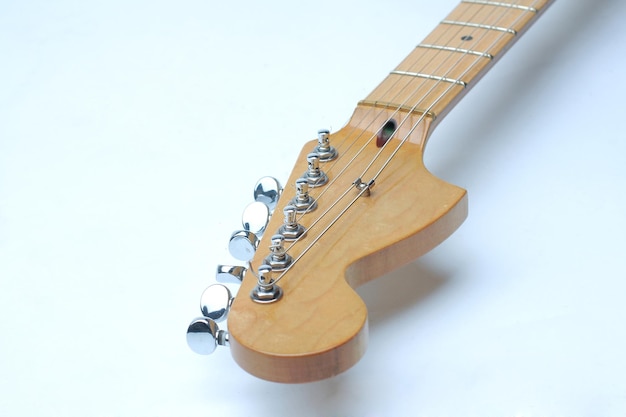 The neck of the guitar on white background