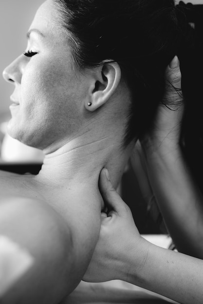 Neck massage in a massage salon woman having a relaxing neck massage