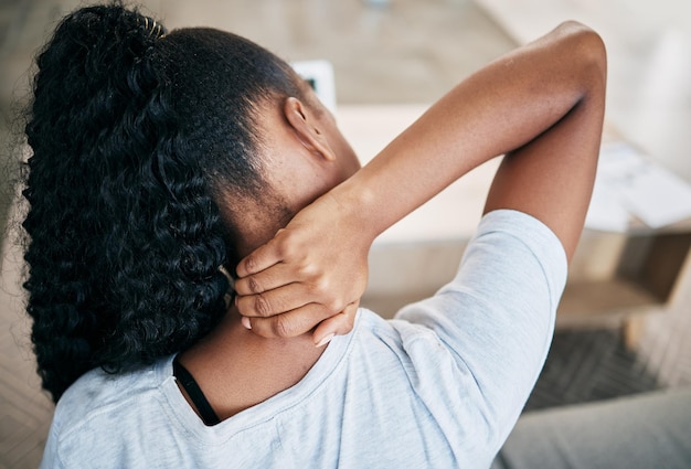 Neck pain stress and back of black woman on sofa with injury joint inflammation and arthritis Health medical care and girl massage muscles for relief from strain muscular tension and body ache