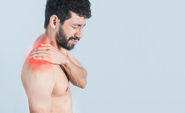 Neck pain and stress concept shirtless man with neck muscle pain Closeup of a man with neck pain a man with neck pain on an isolated background