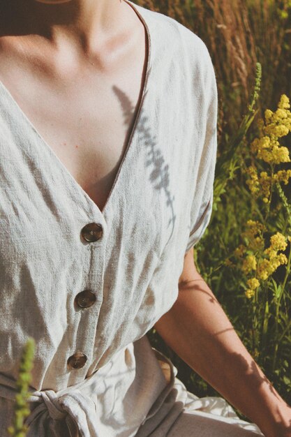 Neck of woman standing on field