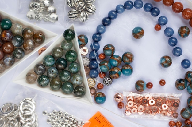 Necklace jewelry stone balls with scissors on the table