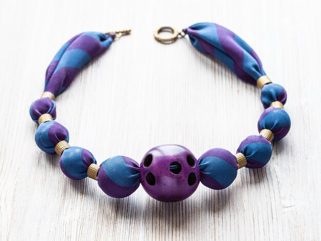 Necklace of round silk beads and purple ball