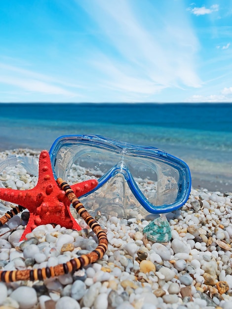 Necklace starfish and diving mask by the shore