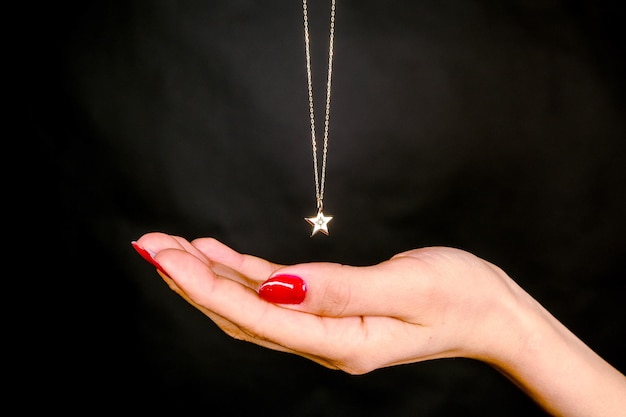 a necklace with a star on it that says  love  on it