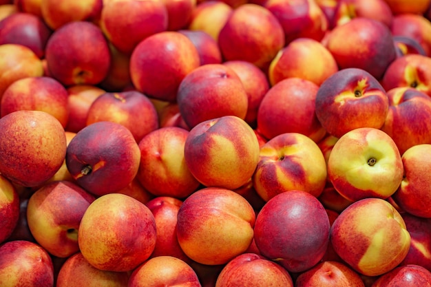 Nectarines peaches whole in bulk on supermarket selective focus