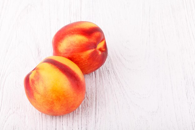 Nectarines on white wooden table