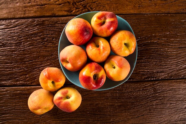 Nectarines on wooden table.