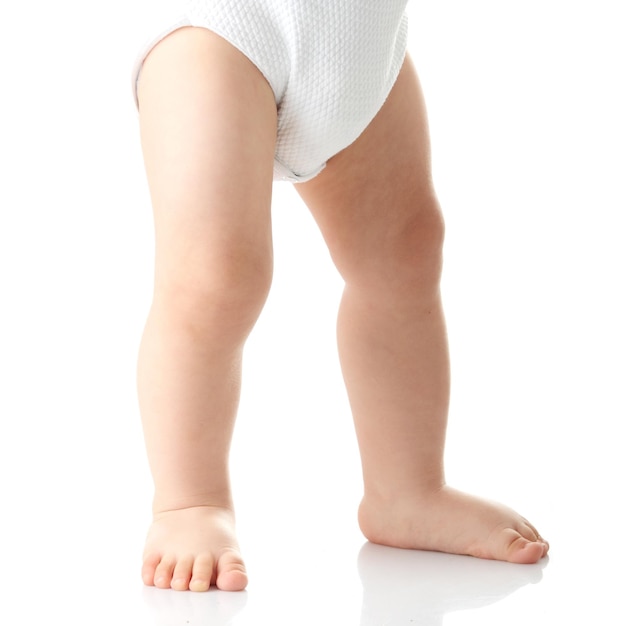 Nederig gedeelte van een baby jongen die tegen een witte achtergrond staat