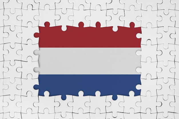 Nederlandse vlag in frame van witte puzzelstukjes met ontbrekend centraal deel